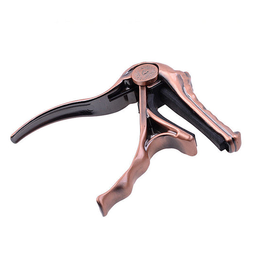 CAPO P/ GUITARRA CON FORMA DE COCODRILO COLOR BRONCE PURPURA A007G/PB N